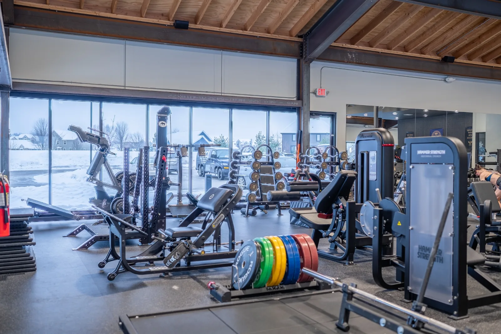 Open lifting platform area at VirtueHall with a rack and mirrored wall under the vaulted wood ceiling